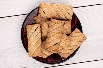 Lot of whole square puff cookie with raisins on white wood