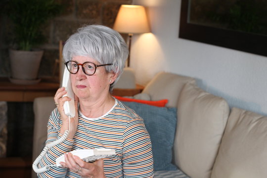 Angry Senior Woman Using Landline Telephone