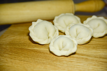 Fototapeta na wymiar Five dumplings of round shape on the wooden deck.