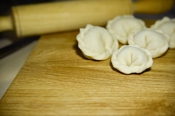 Five dumplings of round shape on the wooden deck.