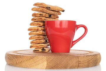 Lot of whole square puff cookie with raisins with red cup on coaster isolated on white