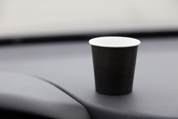 Paper cup on the front of the car.