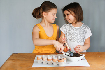 Fototapeta premium Children sow seeds in pots of eggshells, garden