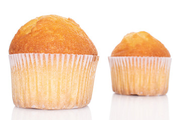 Group of two whole small baked muffin isolated on white