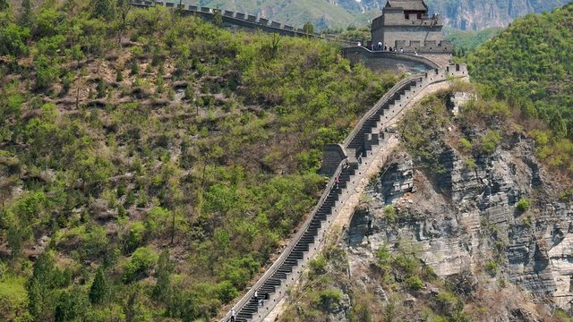 Tourists Walk Along The Great Wall Of China On A Sunny Summer Day