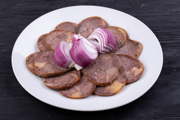 Meat plate with meat stock with red onions
