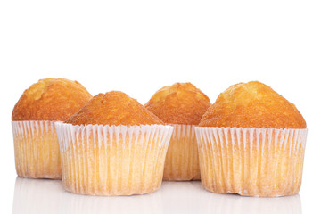 Group of four whole small baked muffin isolated on white