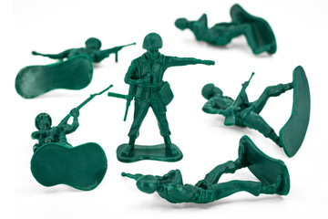 Green toy soldiers on white background. Group of military toys. Picture one on four (1/4).