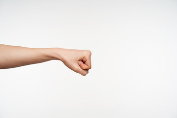 Photo of young pretty female's hand being raised while clenching fingers into fist and moving it...
