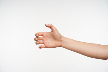 Back view of young pretty woman's hand clenching fingers while being raised, going to take...
