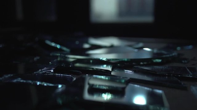 Glass and hands. Mirror broken on the table.