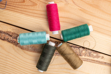 Group of five whole thread spool on wood