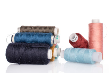 Lot of whole thread spools isolated on white