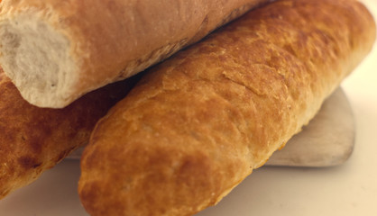Fresh bread, french baton, tiger bread and small baguettes close up, with shallow depth of focus
