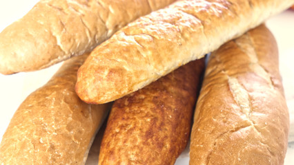 Fresh bread, french baton, tiger bread and small baguettes close up, with shallow depth of focus