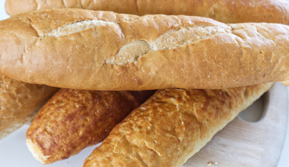 Fresh bread, french baton, tiger bread and small baguettes close up, with shallow depth of focus
