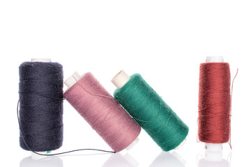 Group of four whole thread spools for sewing isolated on white