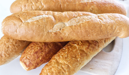 Fresh bread, french baton, tiger bread and small baguettes close up, with shallow depth of focus