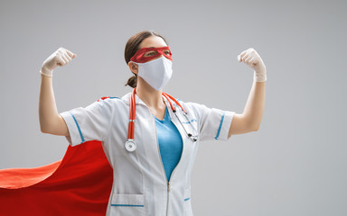 Doctor wearing facemask and superhero cape