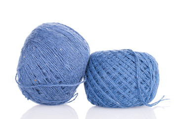 Group of two whole blue thread spool isolated on white