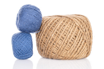 Group of three whole thread spools two blue one beige isolated on white
