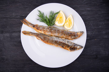 Mackerel fried on grill, served with lemon and dill