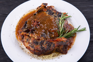 Fried pork meat baked in an oven with sauce and spices