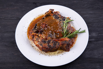 Fried pork meat baked in an oven with sauce and spices