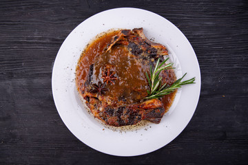 Fried pork meat baked in an oven with sauce and spices