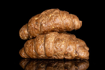 Group of two whole baked wholegrain croissant isolated on black glass