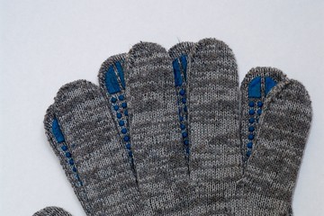 Paired work gloves in gray on a white background, top view.