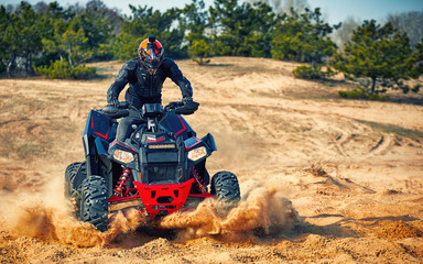 Racing in the sand on a four-wheel drive quad. © Bondariev Volodymyr.