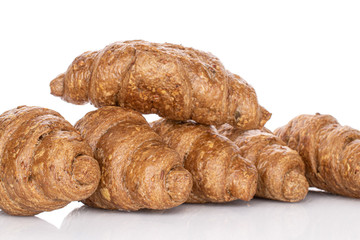 Lot of whole baked wholegrain croissant isolated on white