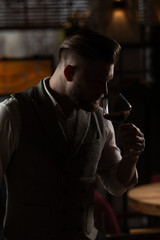 Professional sommelier man with a glass of red wine.