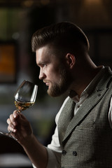 Professional sommelier man with a glass of white wine.