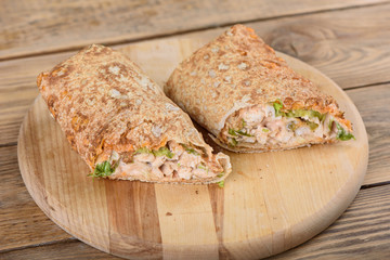 Shawarma Middle Eastern dish of pita bread, stuffed with grilled and then minced chicken meat with spices, sauces and pickled salad.