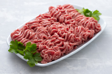 ground meat on white dish on ceramic background