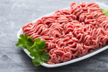 ground meat on white dish on ceramic background