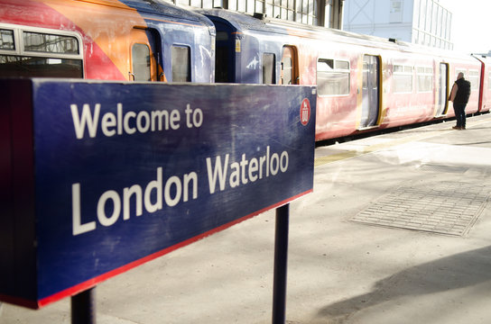 London- Waterloo Station Sign On Platform With South Western Railway Train On Platform. 