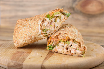 Shawarma Middle Eastern dish of pita bread, stuffed with grilled and then minced chicken meat with spices, sauces and pickled salad.