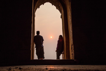 A couple at the door of a temple in Bagan. Myanmar