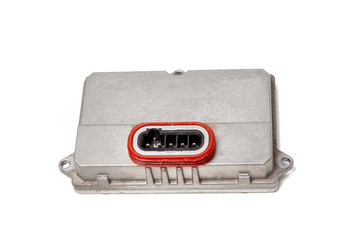 Spare part plastic car engine control unit with metal elements on a white isolated background is the connecting center subsystems, units and assemblies. Rear view of the electronic xenon ignition unit