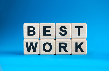 BEST WORK - text on wooden cubes on a blue gradient background