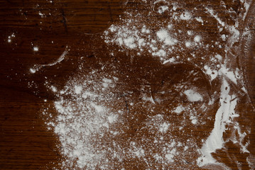 round dough lies on a wooden table sprinkled with flour,pizza dough,smoothed dough is preparing to make dumplings