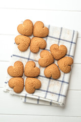 .Ginger cookie on a light napkin on a light background top view copy space.