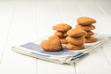 .Ginger cookie on a light napkin on a light background top view copy space.
