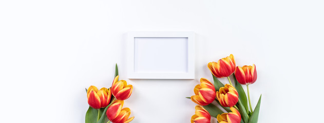 Mother's Day background, tulip flower bunch - Beautiful Red, yellow bouquet isolated on white table, top view, flat lay, mock up design concept.