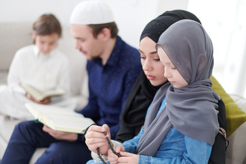 muslim family reading Quran and praying at home