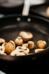 mushrooms are fried in a pan in olive oil