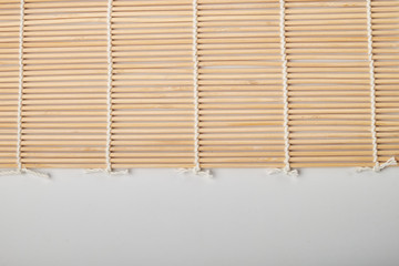 Sushi mat made of bamboo on white background
